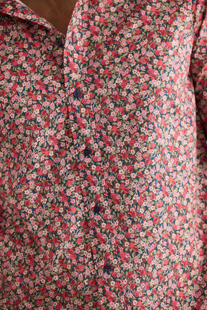 Close-up of a floral patterned fabric with pink and green colors.