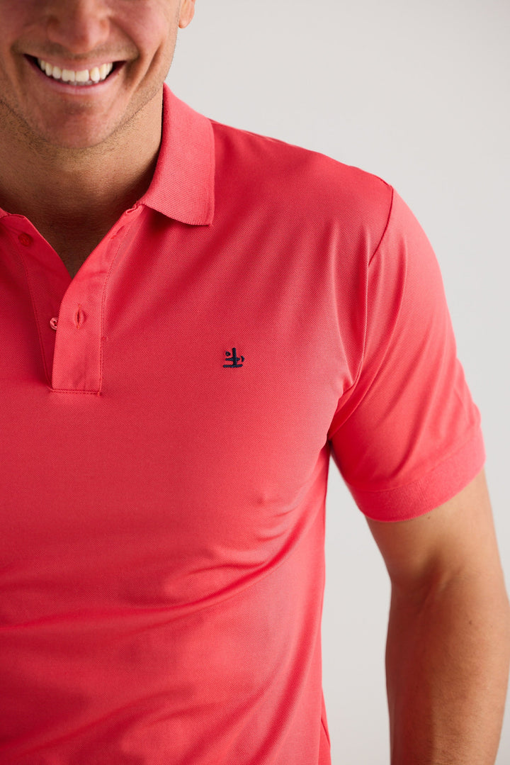 Red polo shirt with a small logo on a plain background
