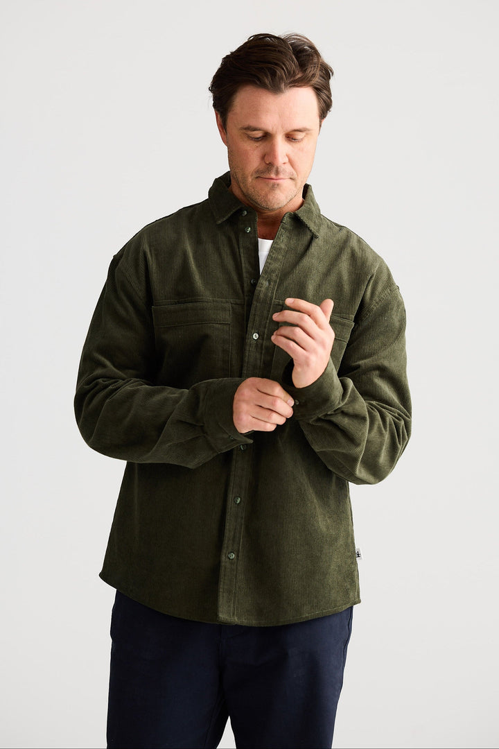 Man wearing a green shirt against a white background