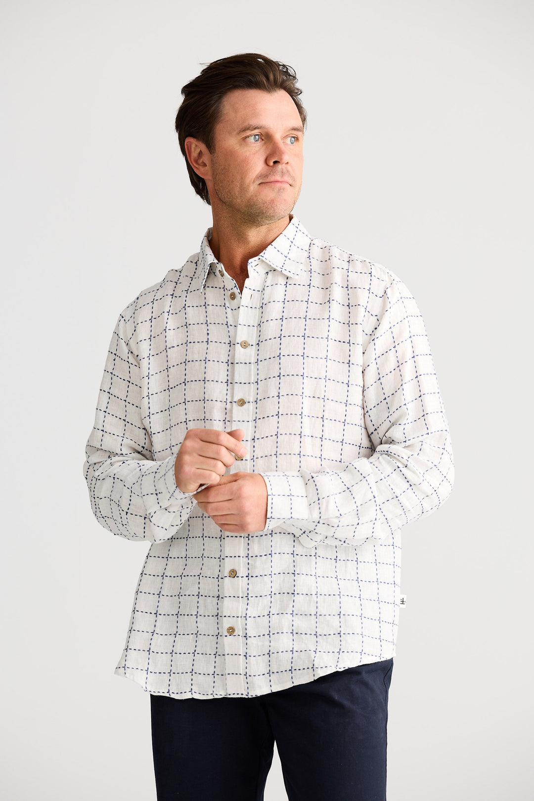 Man wearing a checkered shirt against a white background