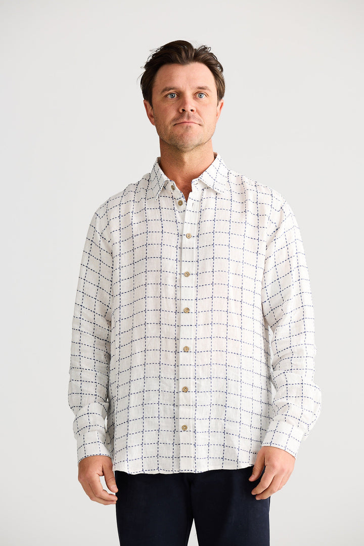 Man wearing a checkered shirt against a plain background