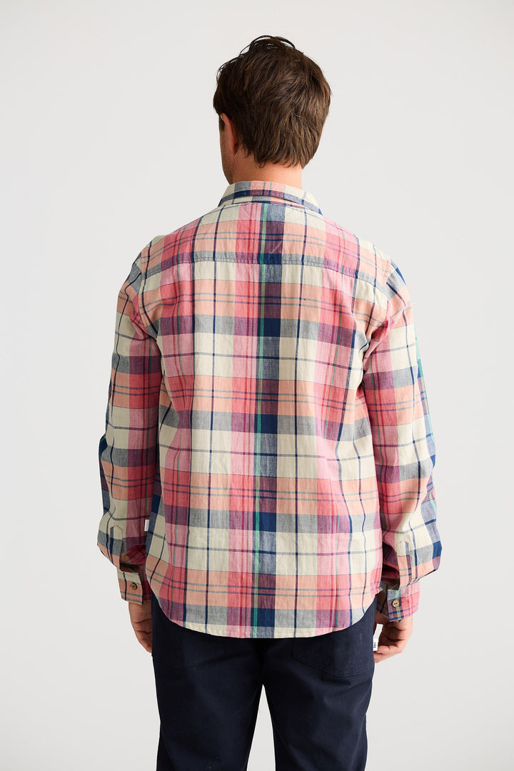 Person wearing a plaid shirt with a plain background