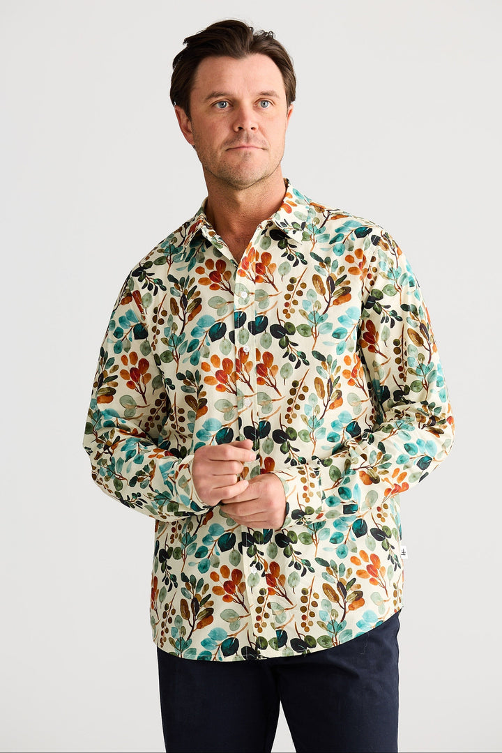 Man wearing a colorful floral shirt against a white background