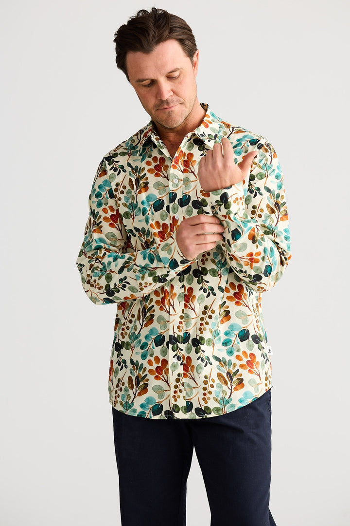 Man wearing a colorful floral shirt against a white background
