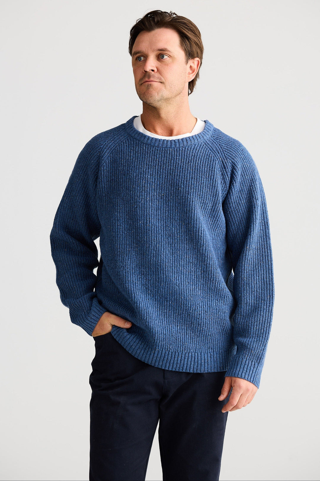 Man wearing a blue sweater against a white background