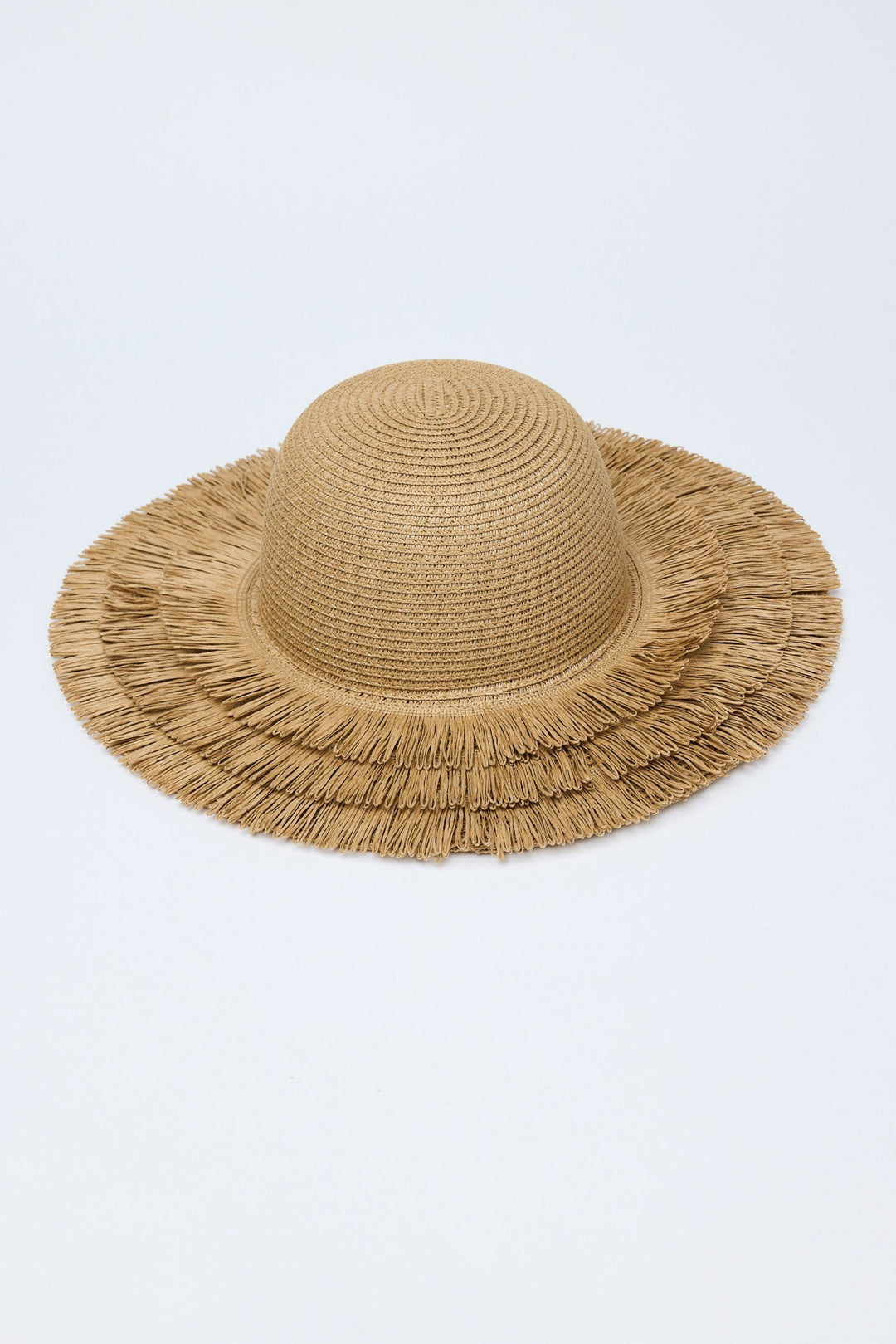 Beige straw hat with frayed edge on a light gray background