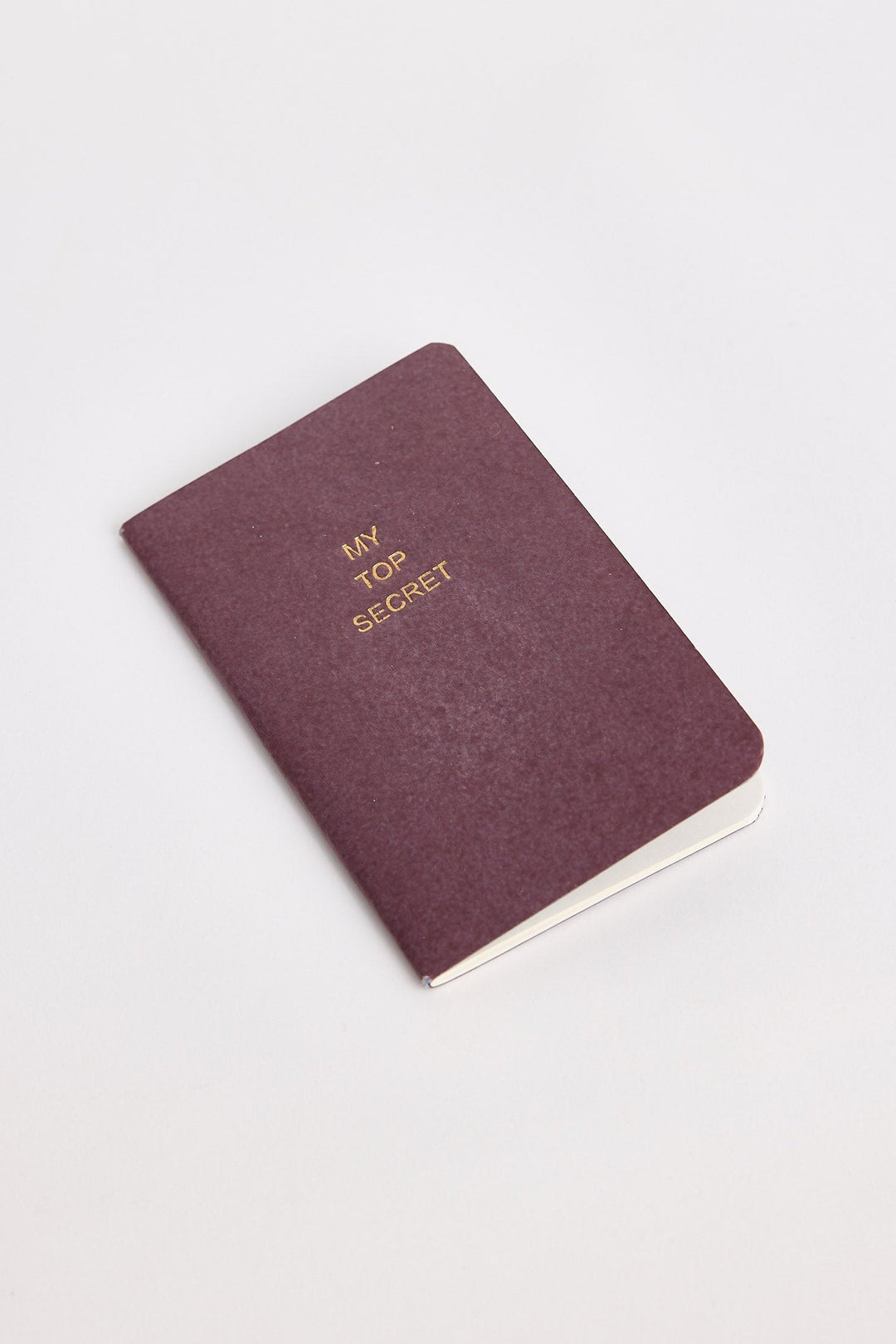 Maroon notebook with 'My Top Secret' text on a white background