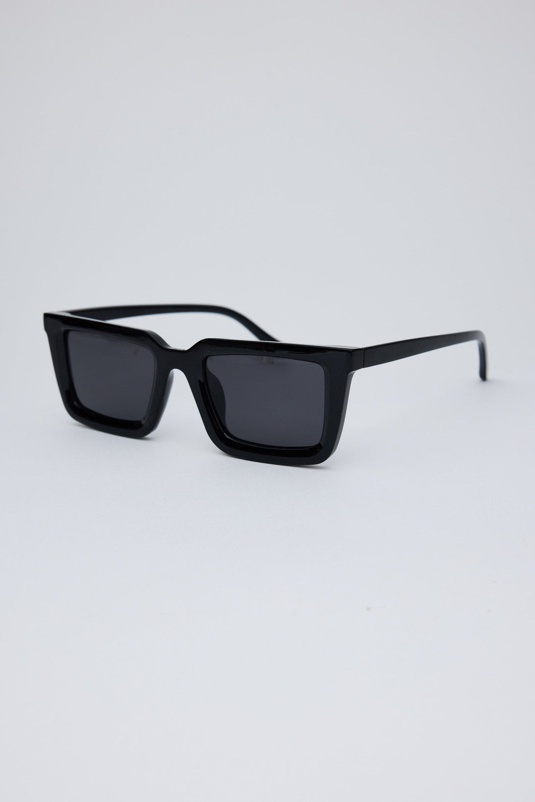 Angled view of Black Coastline Sunglasses on white background