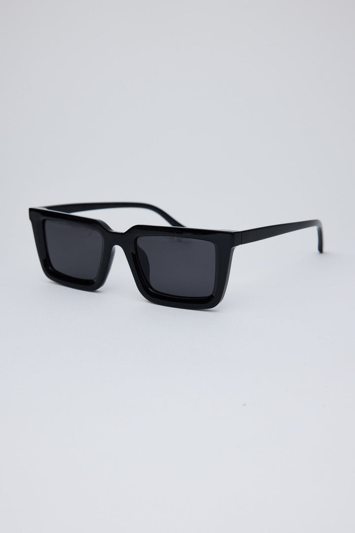 Angled view of Black Coastline Sunglasses on white background