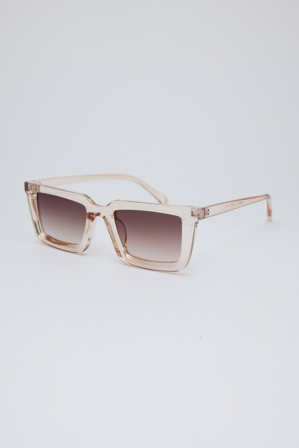 Sunglasses with a gradient lens on a light gray background