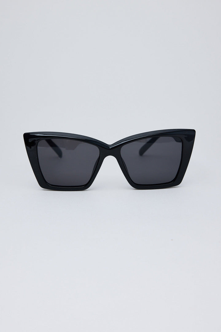 Black cat-eye sunglasses on a light gray background