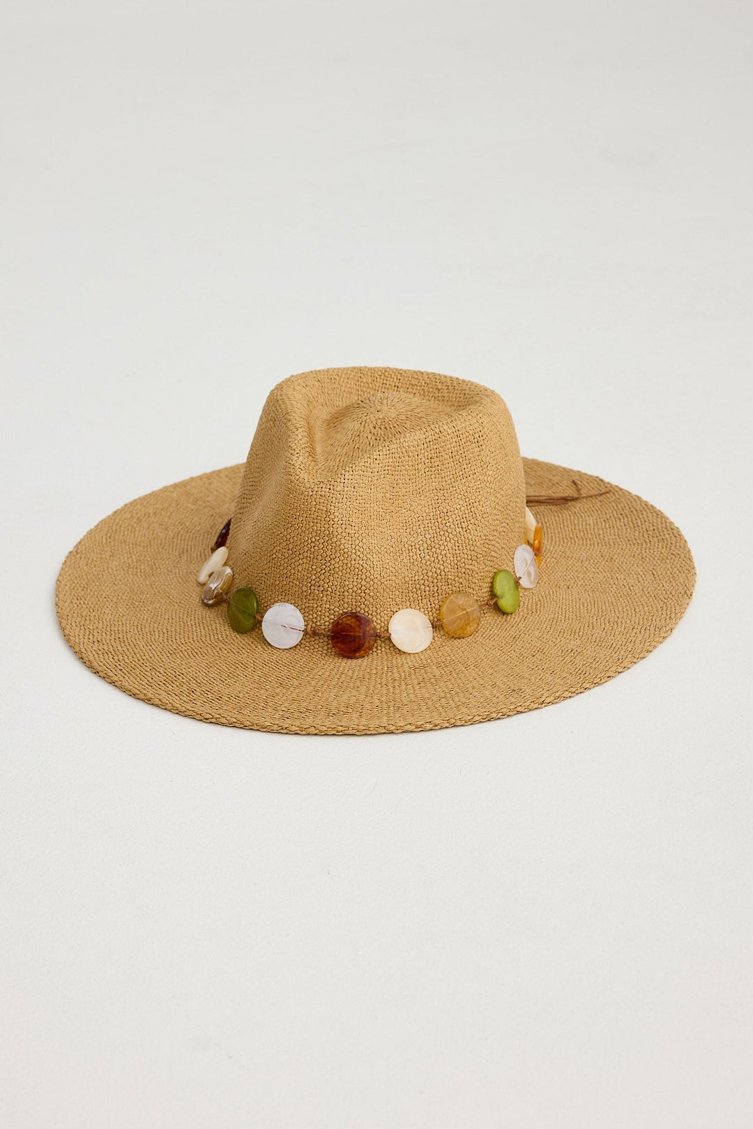 Beige hat with colorful bead embellishments on a light gray background