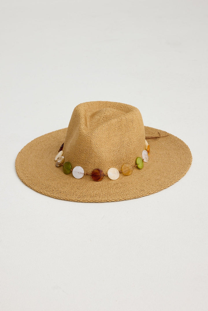 Beige hat with colorful bead embellishments on a light gray background