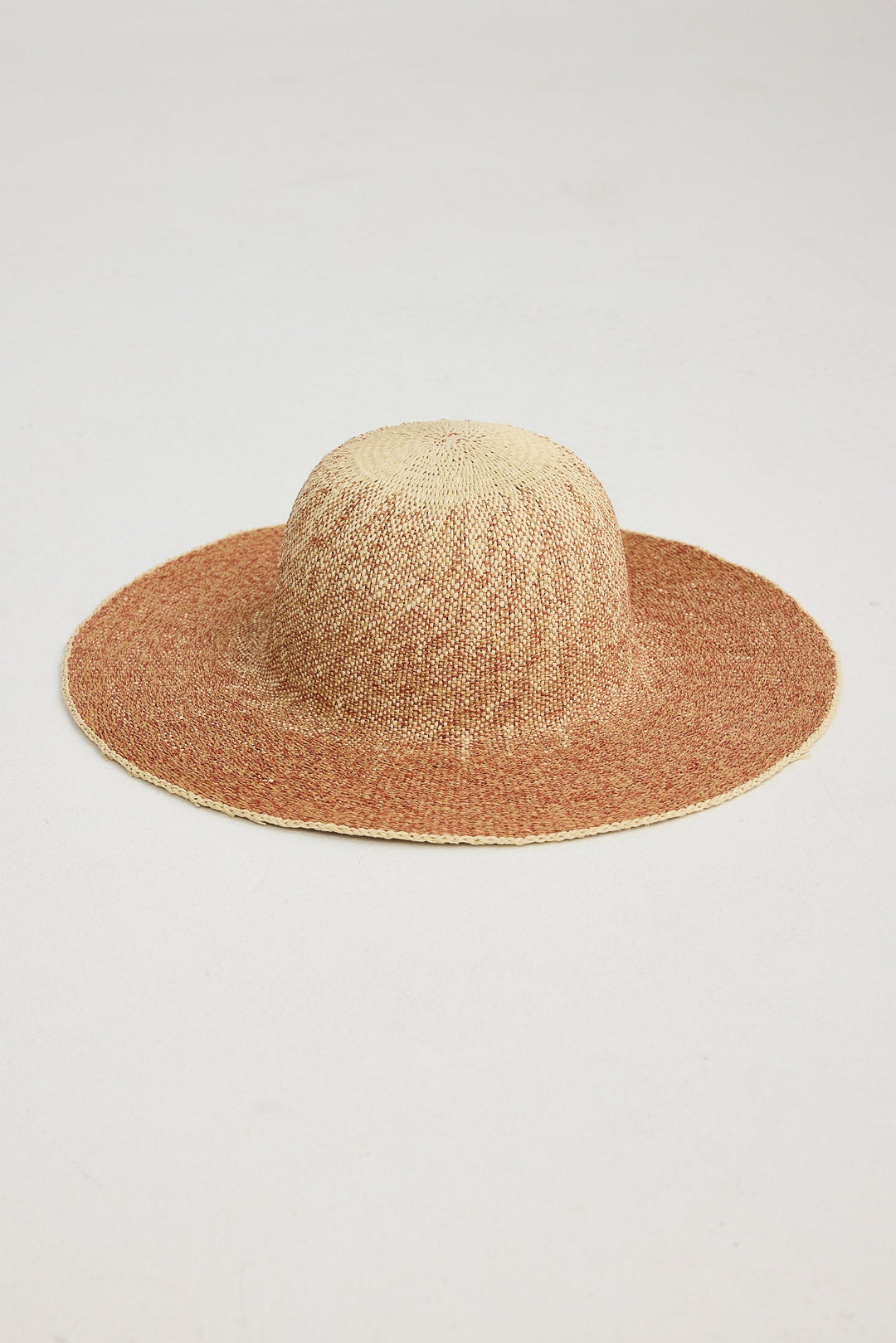 Brown straw hat on a light gray background