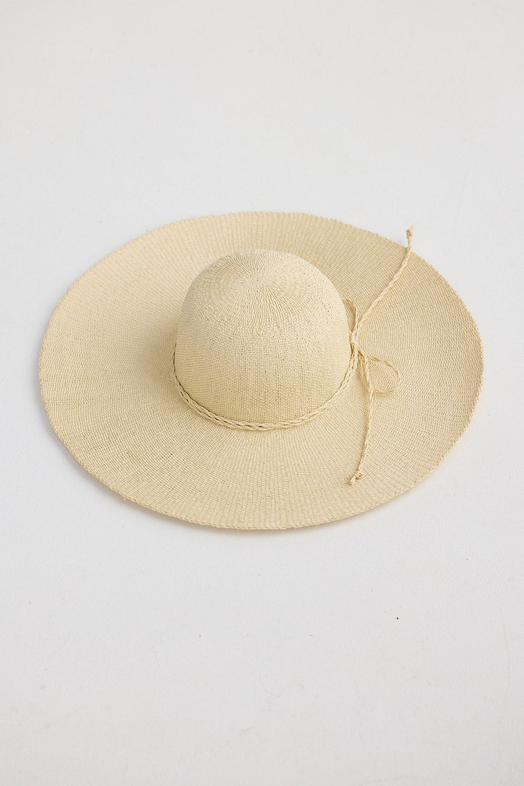 Beige straw hat on a white background