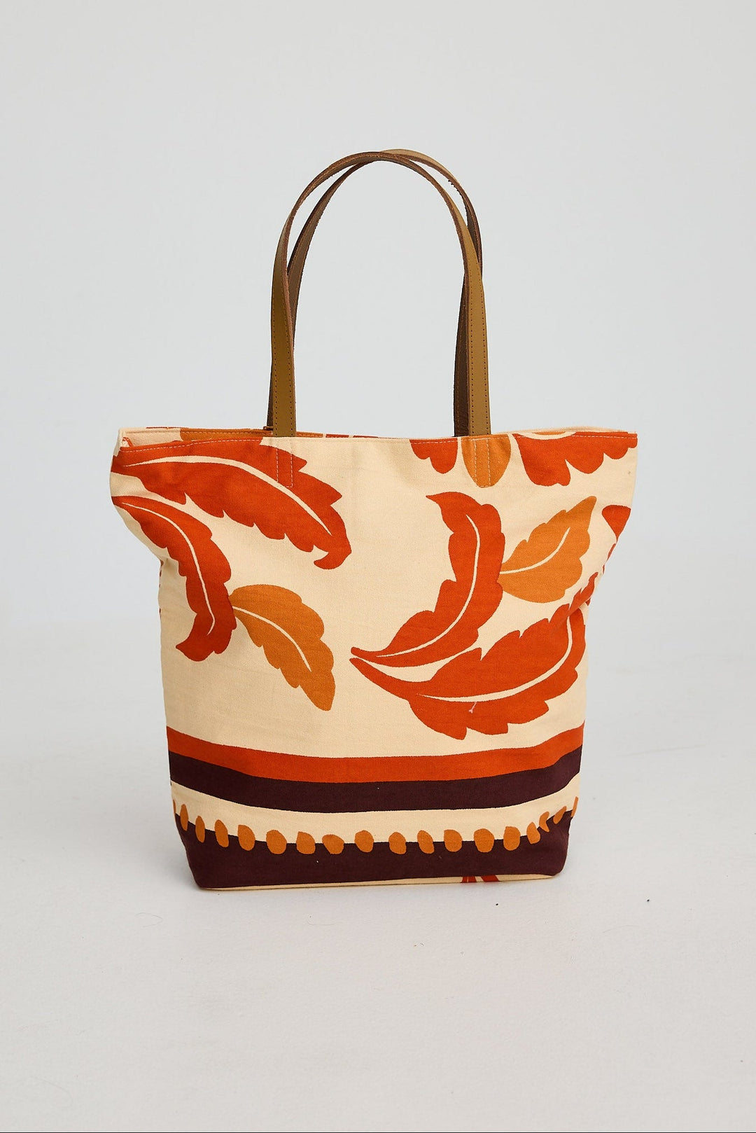 Tote bag with orange floral pattern on a beige background