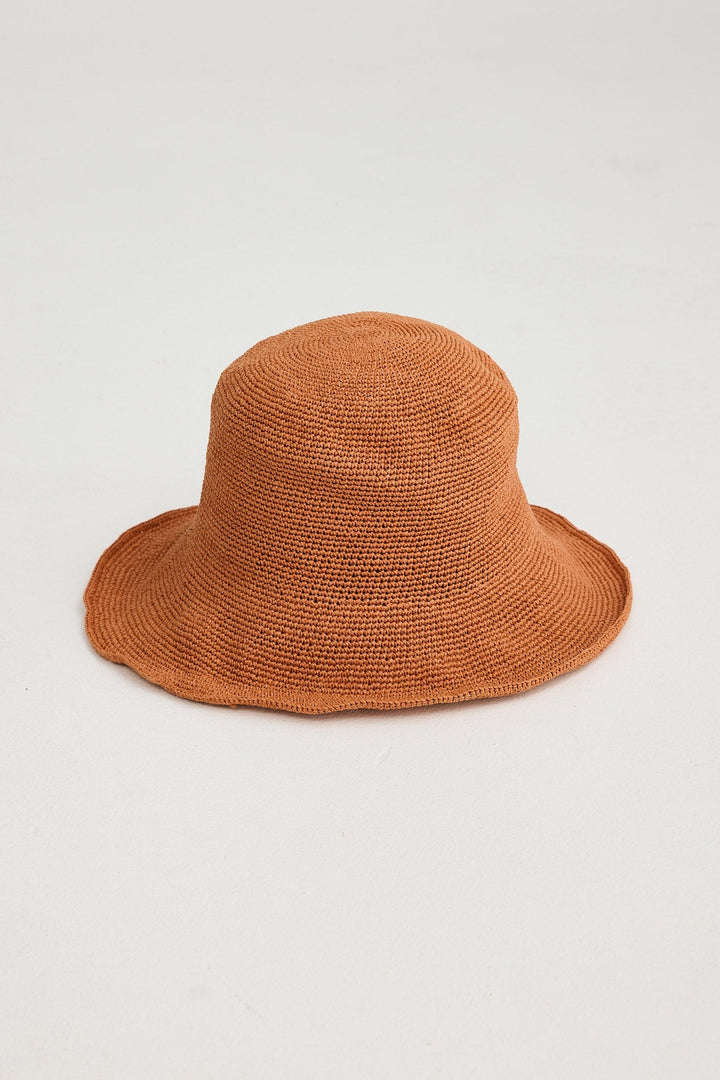 Brown woven hat on a light gray background