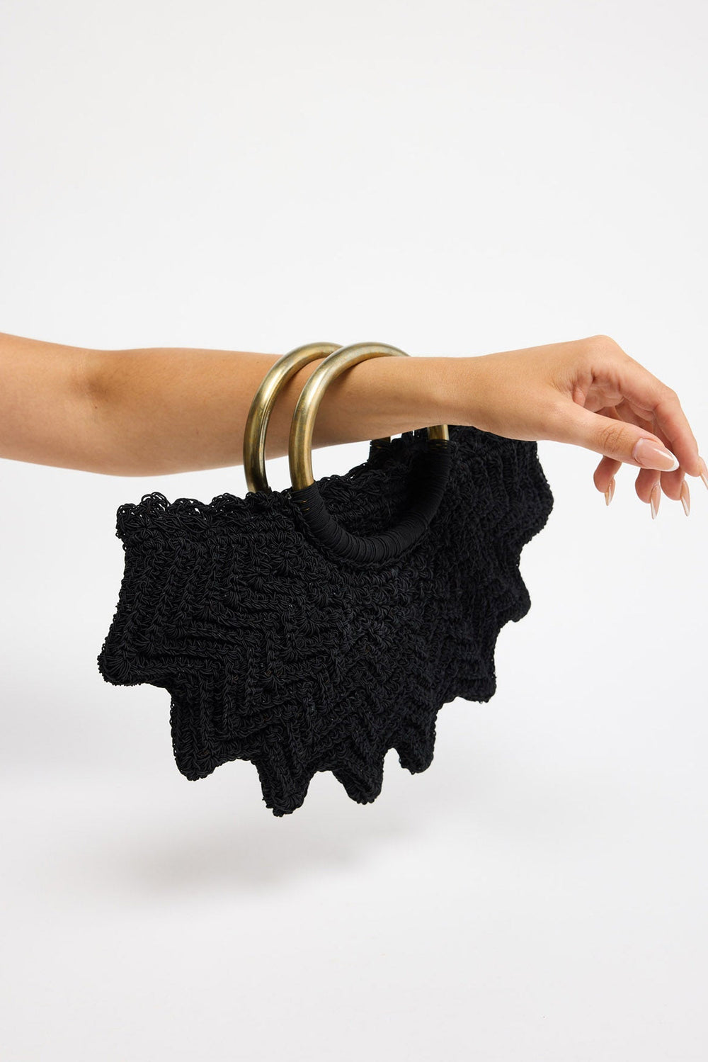 Santana Bag in black - close-up of the ring handles wrapped in cord, worn on the forearm