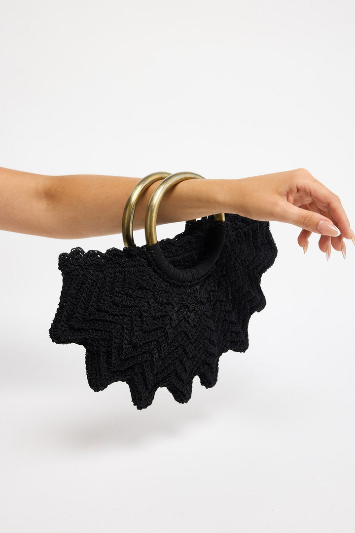 Santana Bag in black - close-up of the ring handles wrapped in cord, worn on the forearm