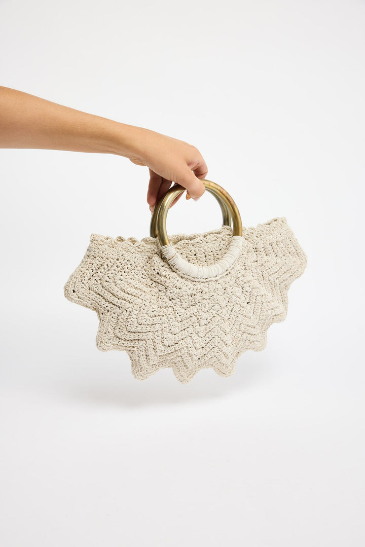 Santana Bag in off white worn on the arm, side view styled with a white halter dress