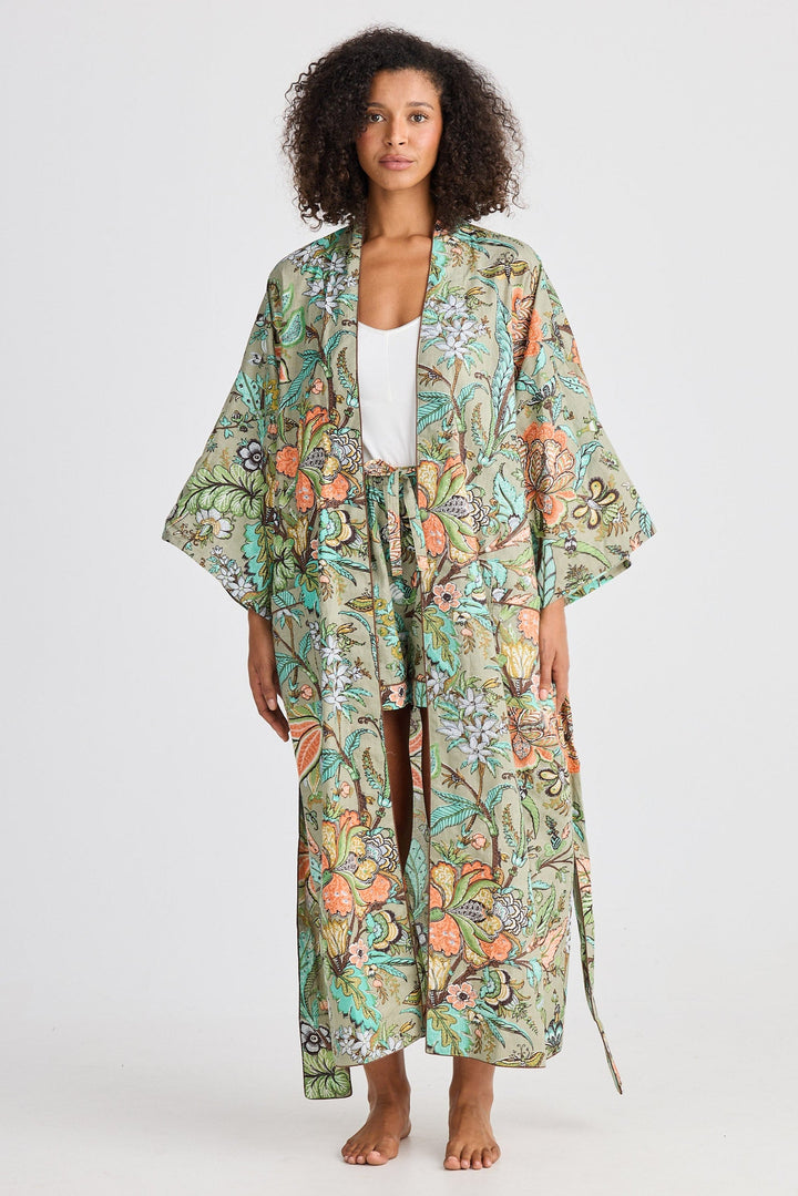 Woman wearing a floral kimono-style robe on a white background