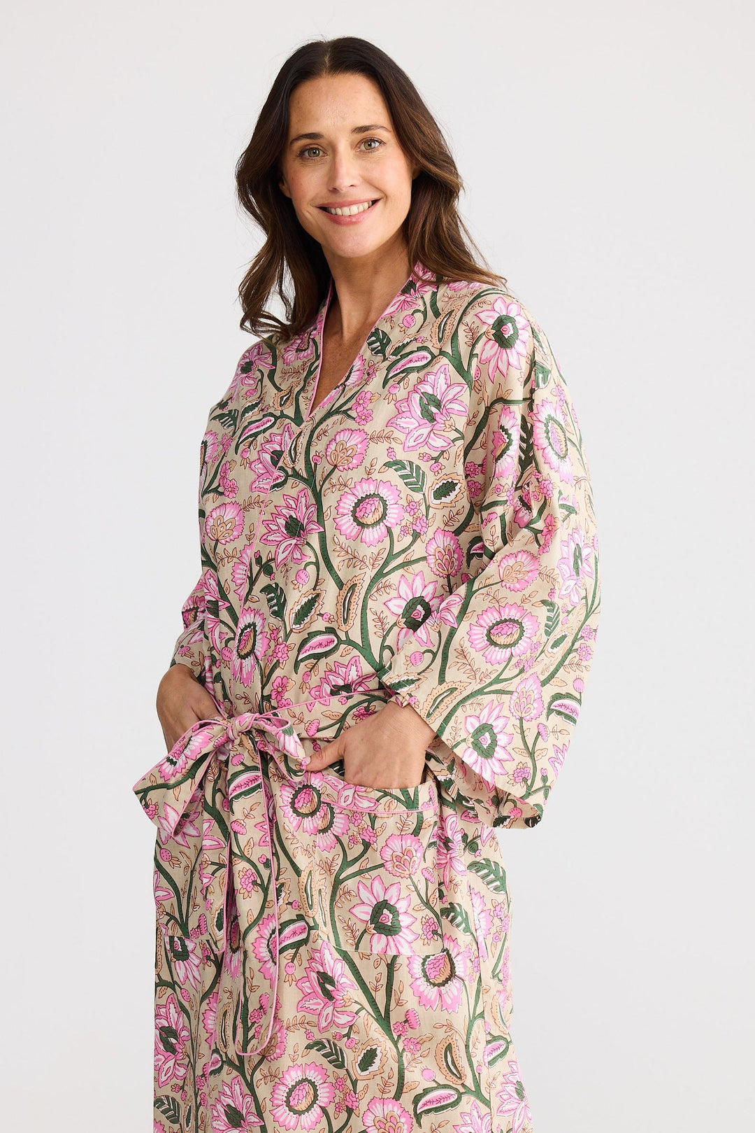Woman wearing a floral patterned robe on a white background