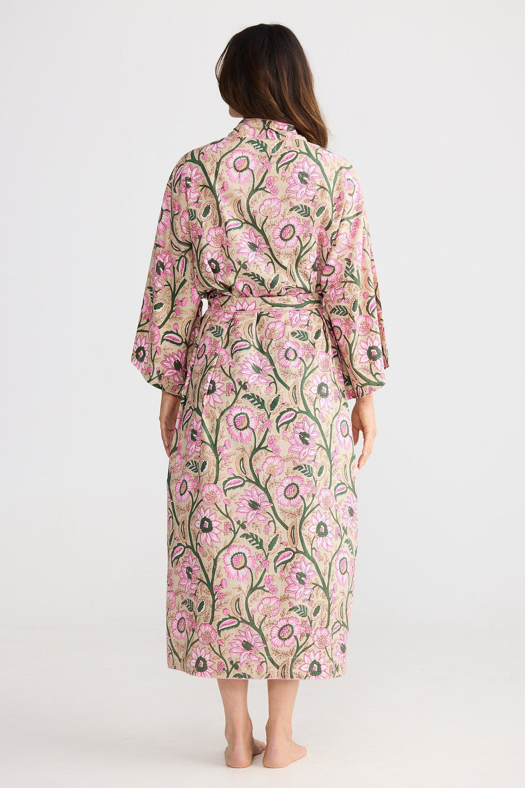 Woman wearing a floral robe with a white background