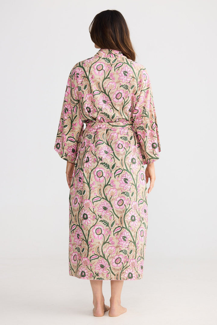 Woman wearing a floral robe with a white background