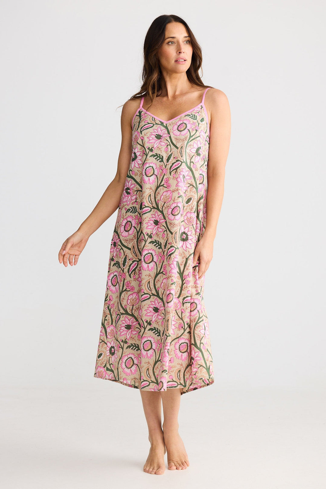 Woman wearing a pink floral dress on a white background