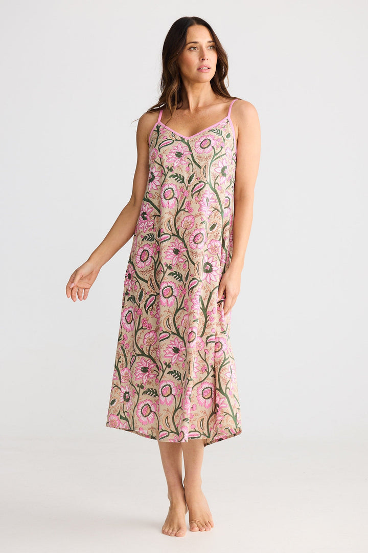 Woman wearing a pink floral dress on a white background