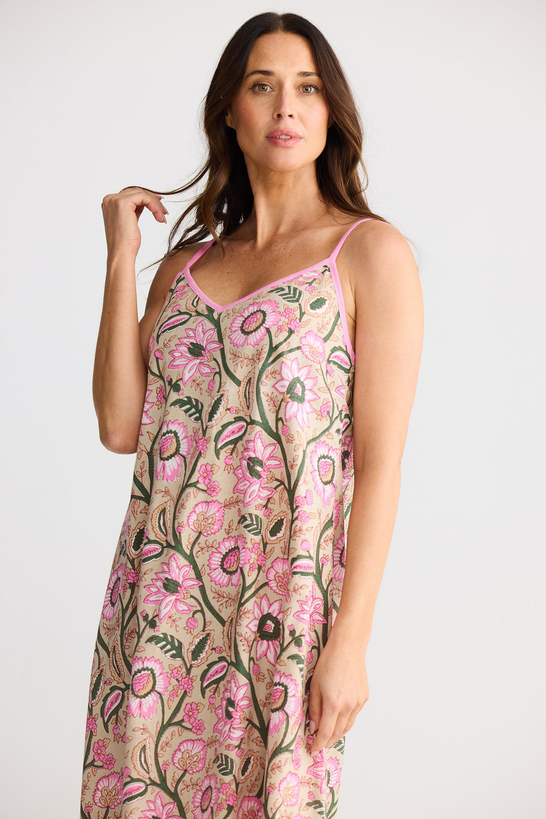Woman wearing a floral slip dress on a white background