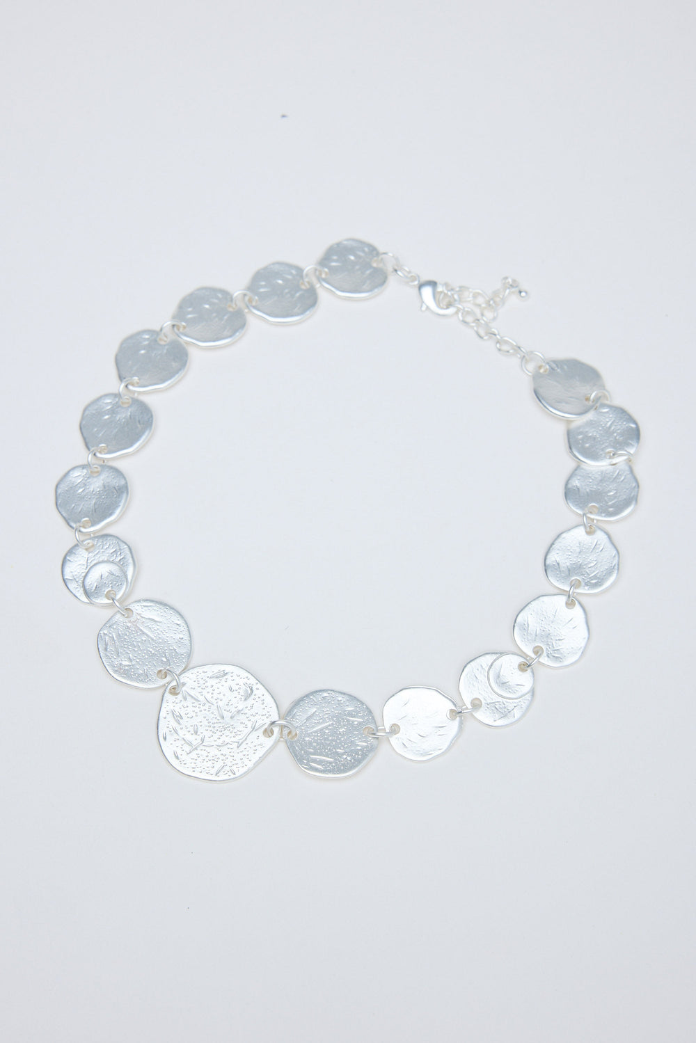Necklace with gray and silver circular coins on a white background