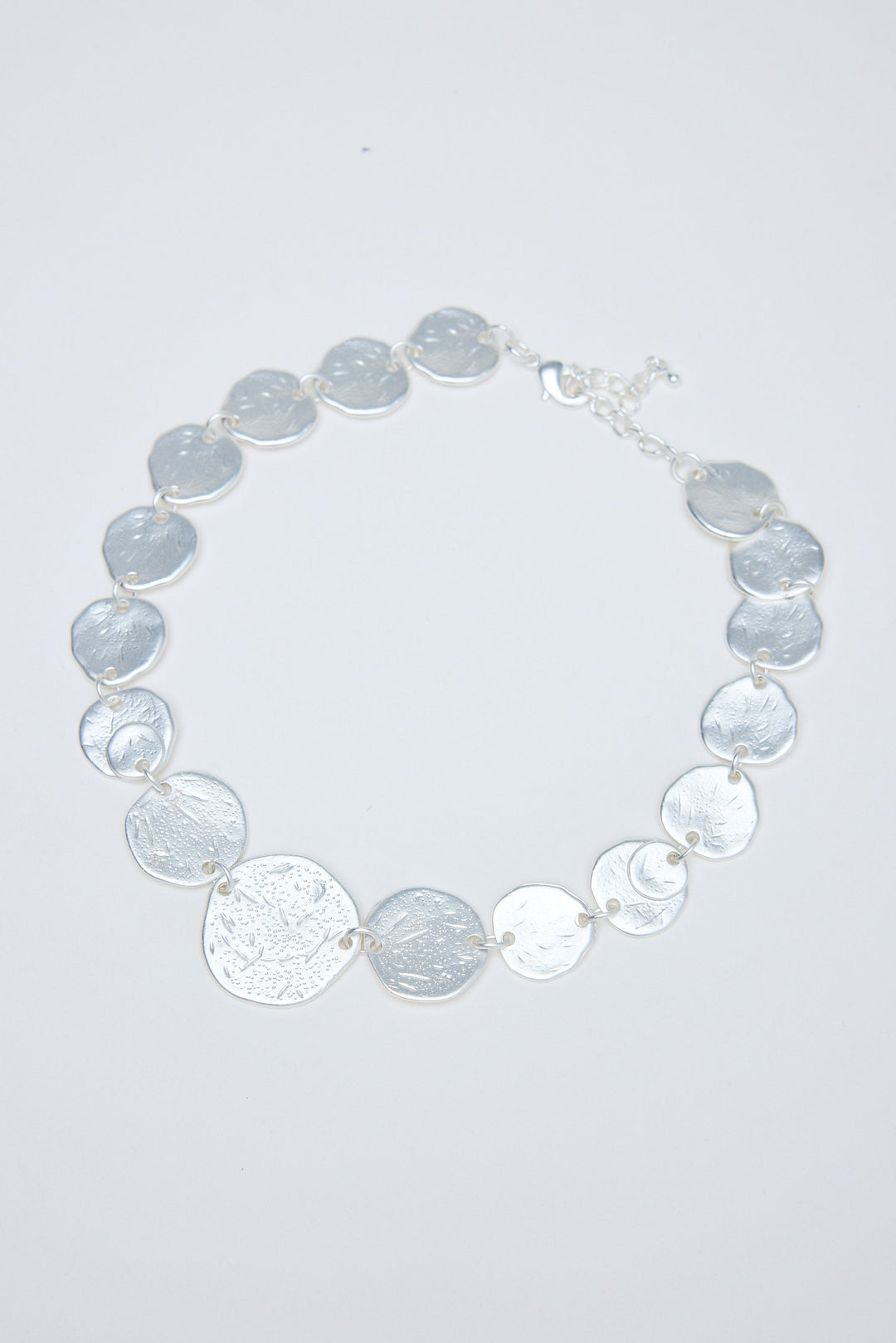 Necklace with gray and silver circular coins on a white background