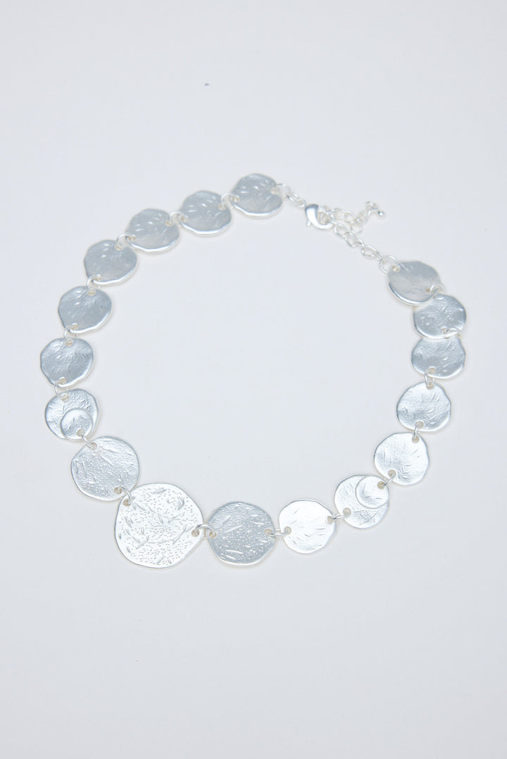 Necklace with gray and silver circular coins on a white background