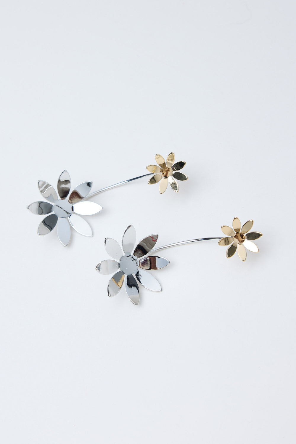 Floral-shaped earrings on a light gray background