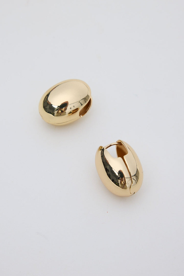 Gold hoop earrings on a light gray background