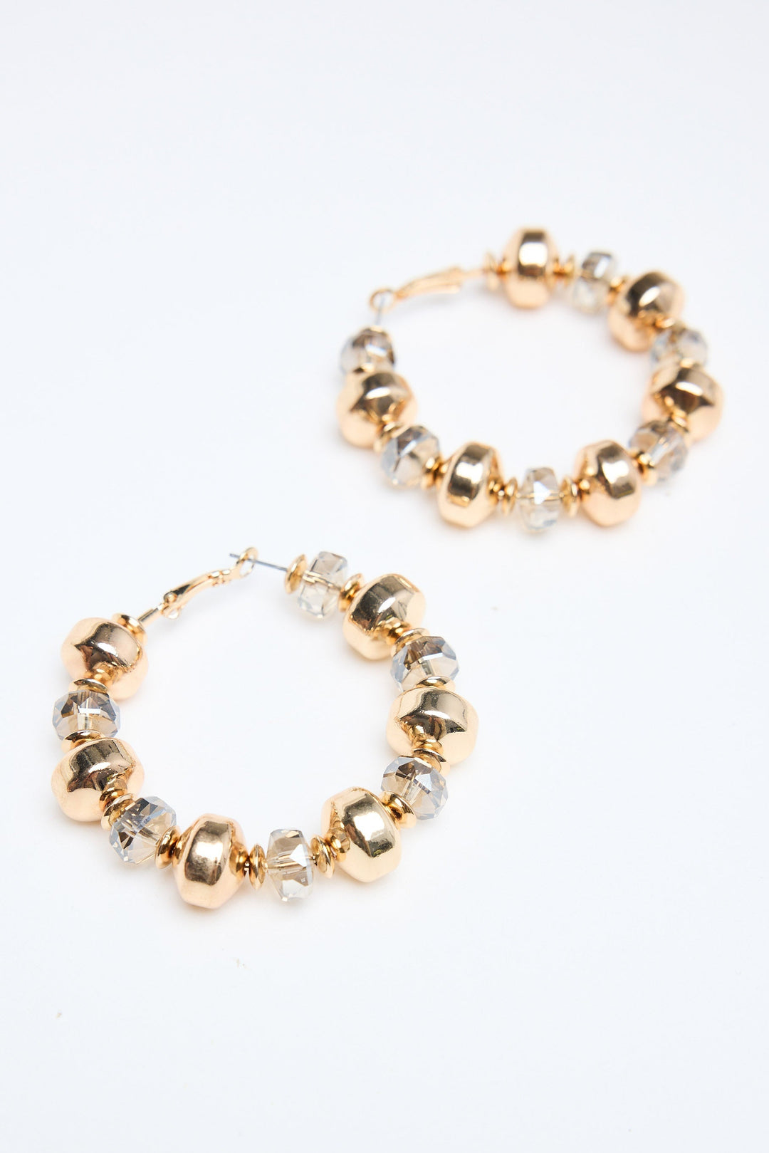 Gold and silver beaded hoop earrings on a white background
