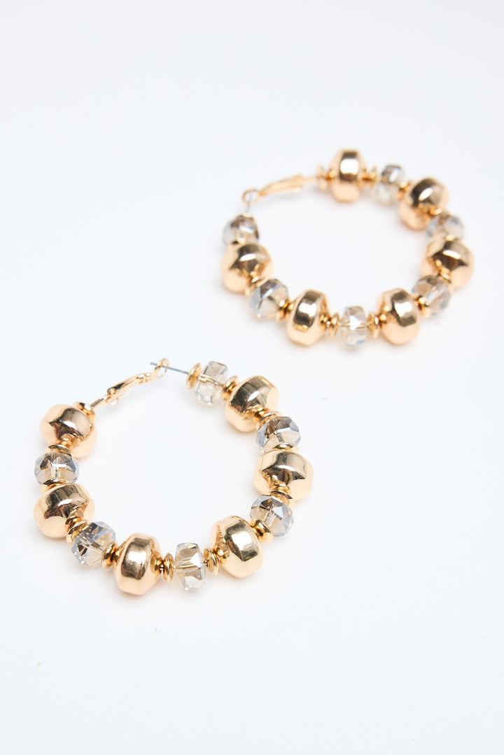 Gold and silver beaded hoop earrings on a white background
