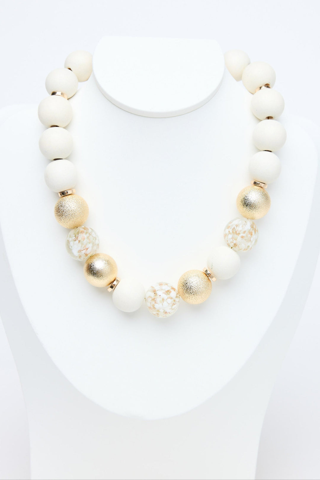 Necklace with white and gold beads on a white background