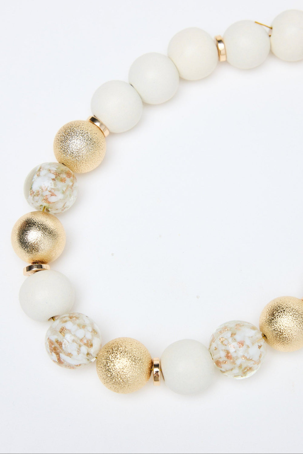 Necklace with white and gold beads on a white background