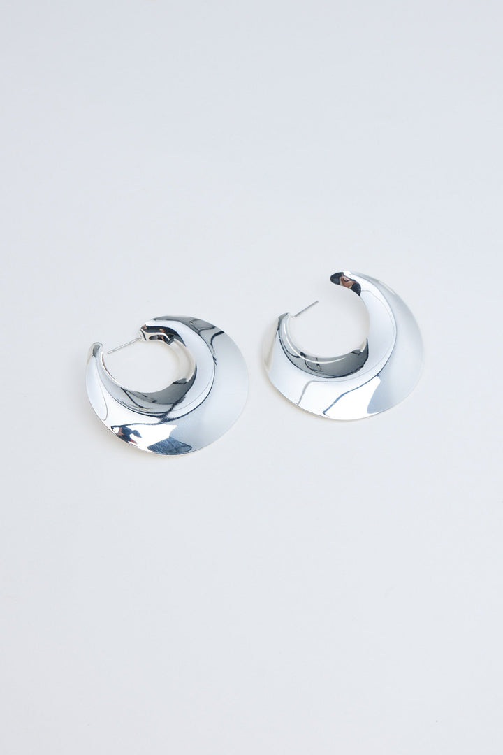 Pair of silver hoop earrings on a light gray background
