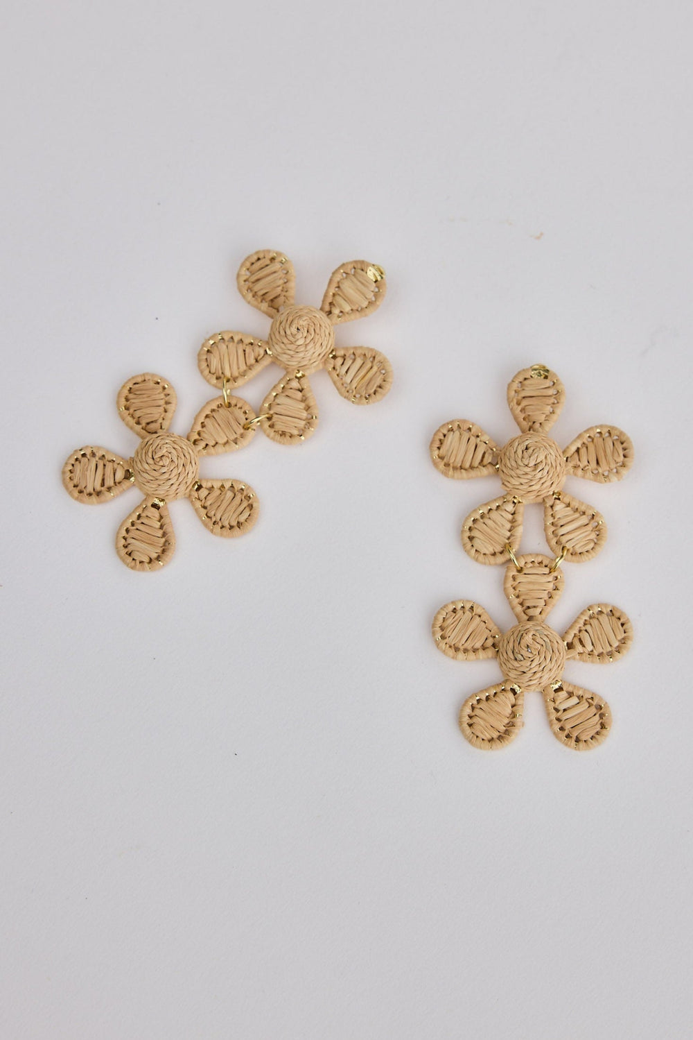 Pair of natural floral earrings on a light gray background