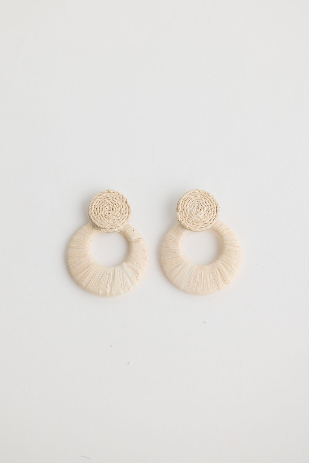 Close-up of natural eloise earrings earrings on white background.