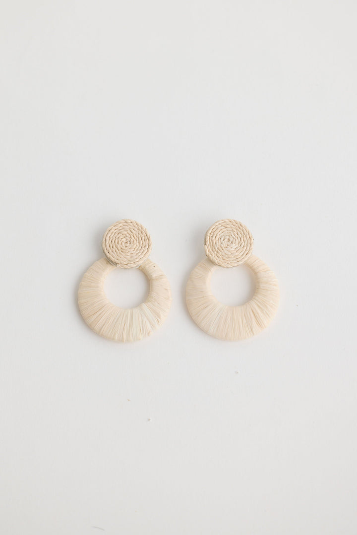 Close-up of natural eloise earrings earrings on white background.
