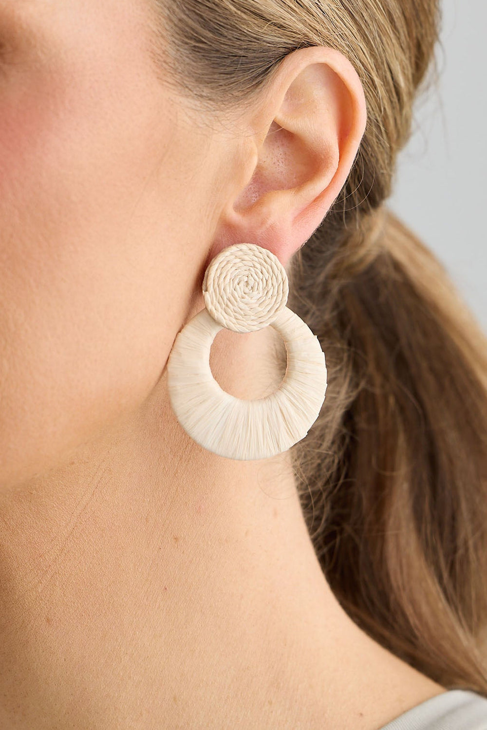 Close-up of natural eloise earrings earrings on white background.