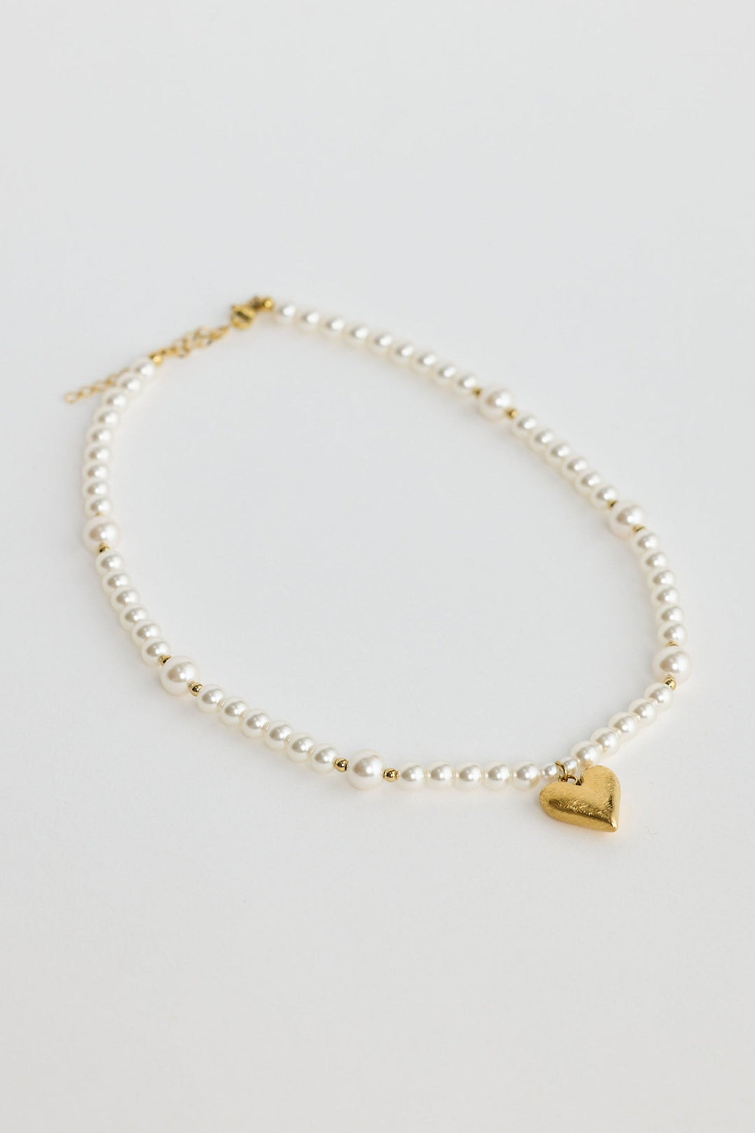 Close-up of pearl mia necklace necklace on white background.