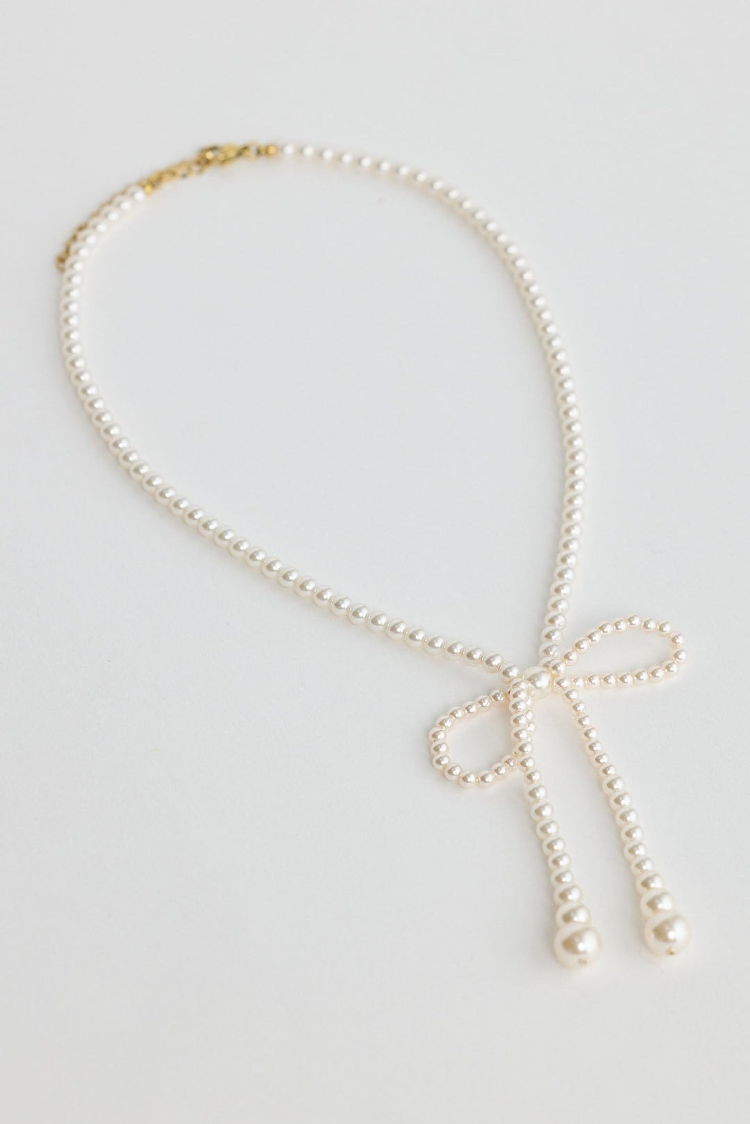 Close-up of pearl ella necklace necklace on white background.