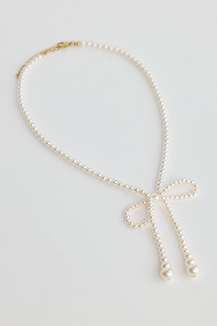 Close-up of pearl ella necklace necklace on white background.
