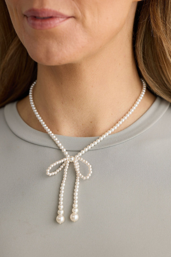 Close-up of pearl ella necklace necklace on white background.