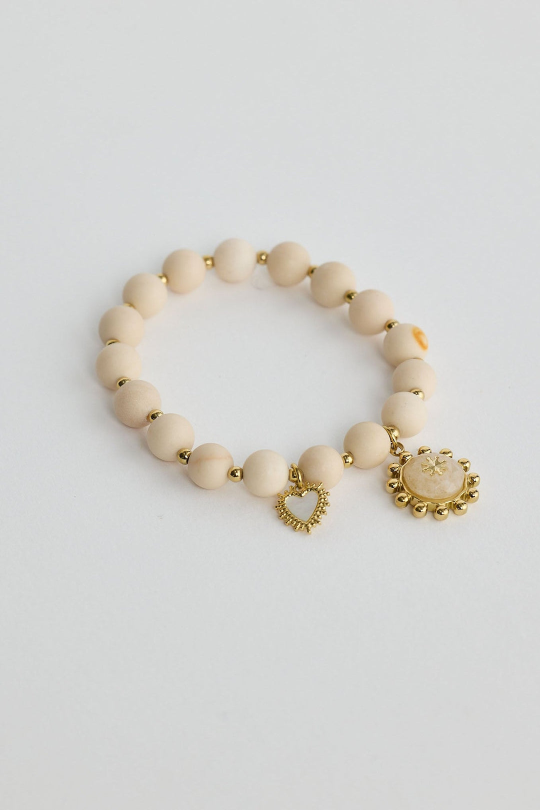 Close-up of bone serenity bracelet bracelet on white background.